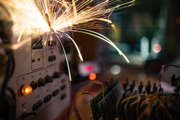 Electronic sparks scatter quickly and sharply from a short circuit on technological equipment in the instrument room stock photo