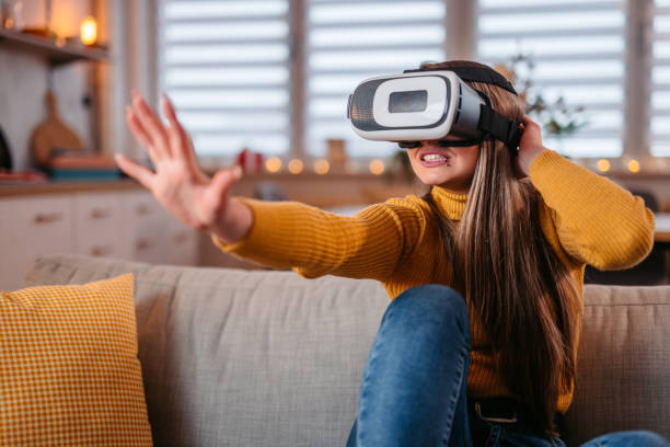istock Young Woman Wearing A Virtual Reality Headset At Home 1371331611