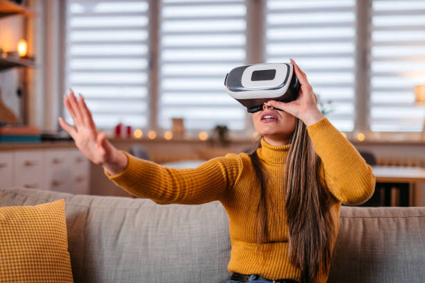 istock Young Woman Wearing A Virtual Reality Headset At Home 1371331769