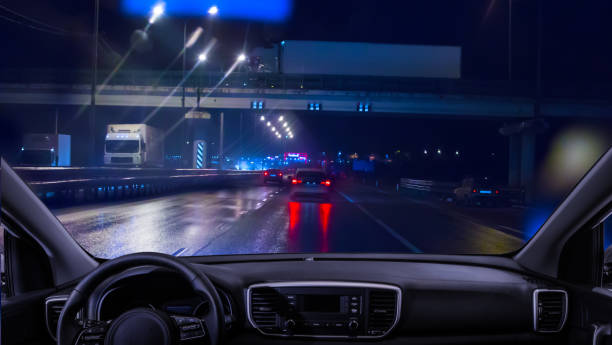 View from the car to the traffic on the night highway View from the car to the traffic on the night city highway car point of view stock pictures, royalty-free photos & images