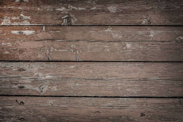 Background of old wooden planks painted brown peeling paint