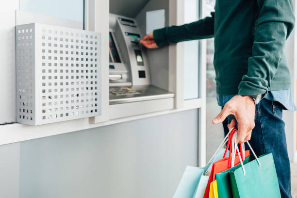 istock Man Withdrawing Money From ATM 1371336669