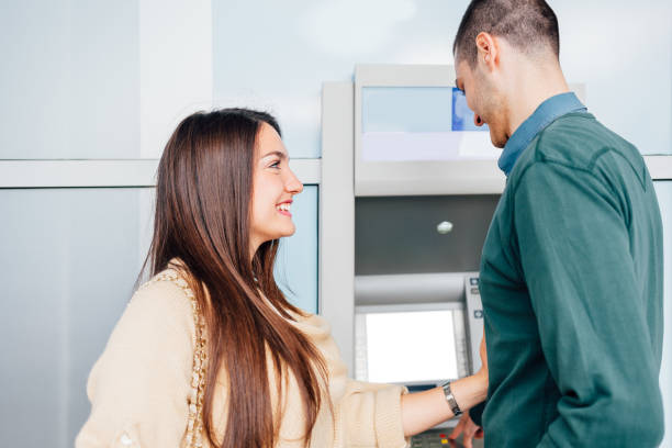 istock Man Withdrawing Money From ATM 1371336700