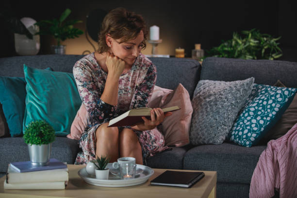 istock Woman relaxing with a romantic novel 1371337850