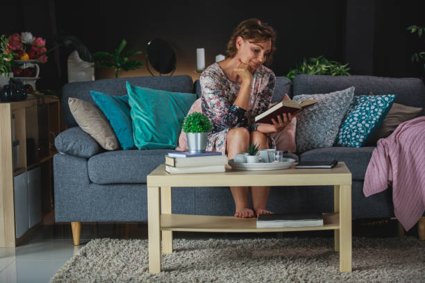 istock Woman on a coffee break enjoying a romantic novel she is reading 1371337863