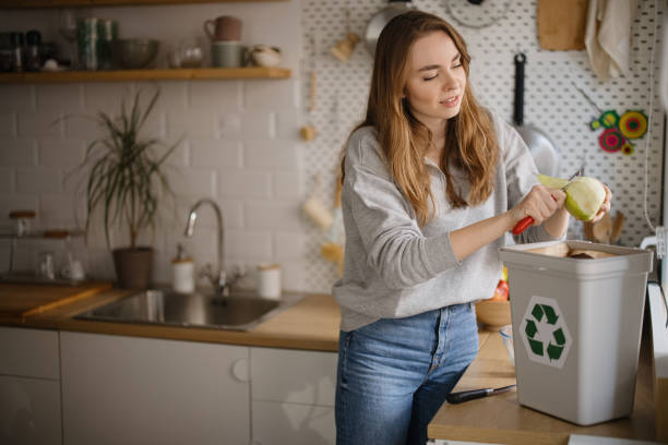 istock Young woman peeling apple into the recycling bin 1371338758