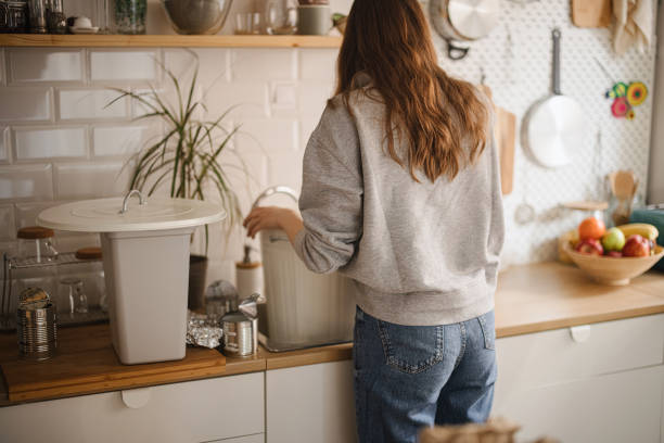 istock Woman recycling plastic waste at home 1371338914
