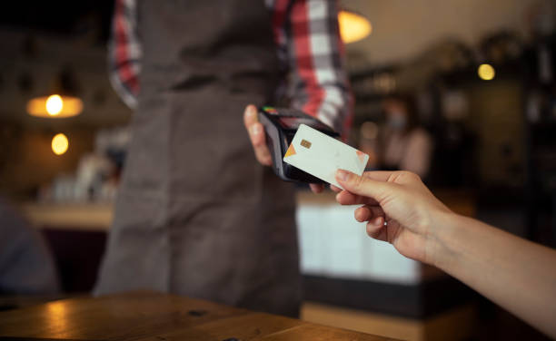 istock Waiter with reader accepting credit card payment. 1371339301