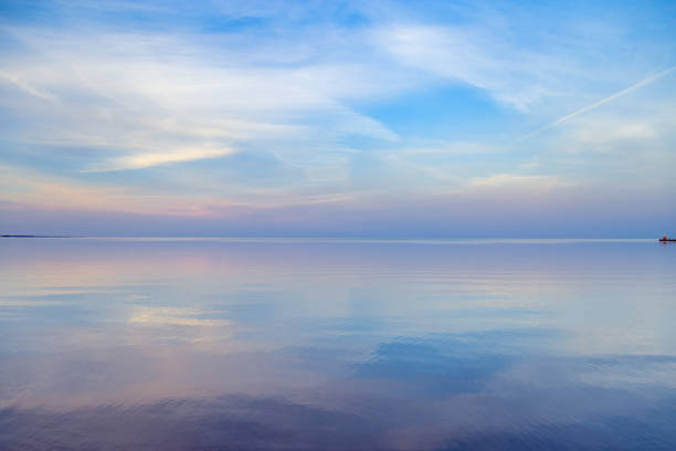 istock Sky background on sunset, colorful clouds. Nature abstract composition with reflections on sea water. Nature environment. 1371341611