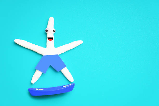 Cute starfish character riding a toy surfboard isolated on a light blue background. Creative active vacation concept.
