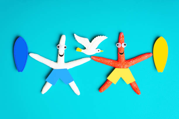 istock Starfish characters with surfboards and a seagull 1371342548