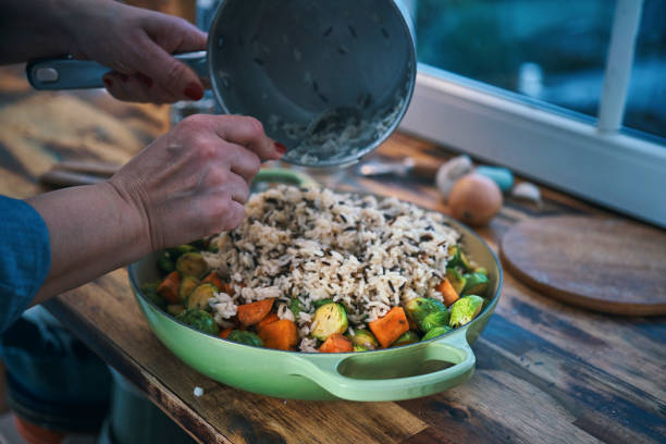 Preparing Farmers Harvest Chicken Casserole with Wild Rice, Brussel Sprouts, Kale, Onion and Sweet Potatoes