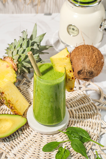 Healthy Green smoothie drink with avocado, pineapple, coconut and spinach