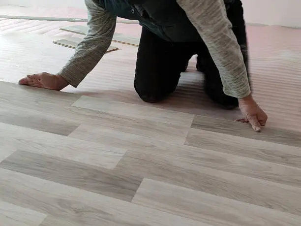 Photo of installation of laminate flooring in the living room close-up