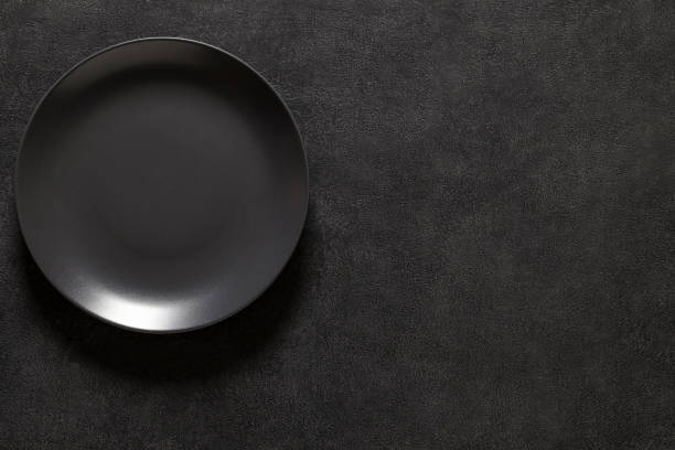istock Plate is gray round empty, top view dark background, with space to copy text. 1371343985