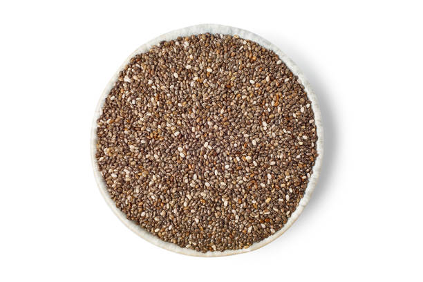 Bowl of chia seeds on white background Bowl of chia seeds isolated on white background. Top view, clipping path salvia hispanica plant stock pictures, royalty-free photos & images