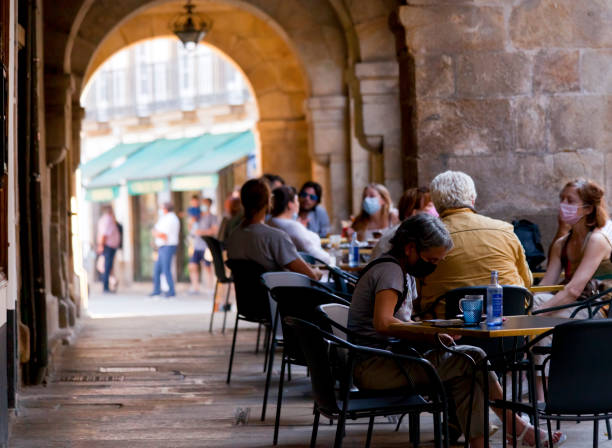 Street view in old town Santiago de Compostela, stone arcade with sidewalk cafes. stock photo