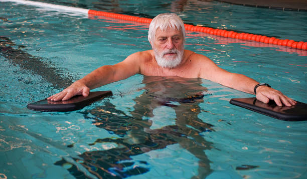 istock Parkinson Disease patient in pool exercising - balance 1371348472