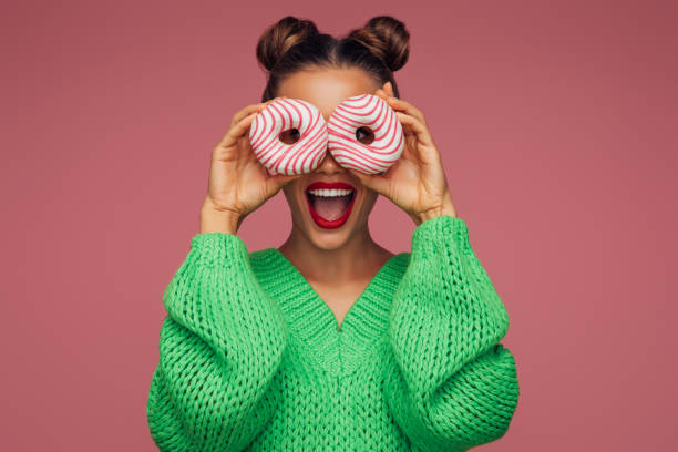 istock Beautiful woman holding donuts 1371348777