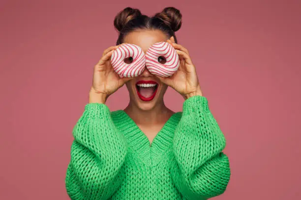 Photo of Beautiful woman holding donuts