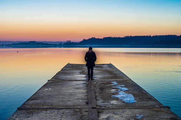 istock man on the jetty at the lake 1371349491