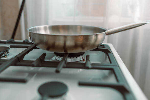 istock Frying pan on white gag stove in kitchen. Cooking. 1371352113