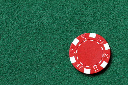 red poker chip on a table