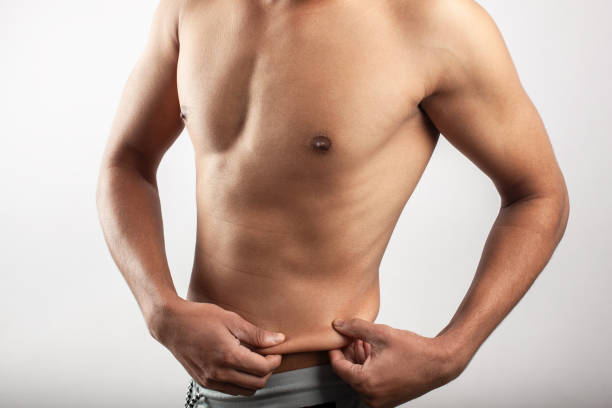 istock slim man showing belly fat 1371358219