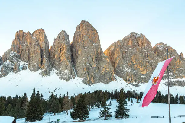 Photo of Odle mountains chain separating the Funes valley from the Gardena valley take from the Gaisler refuge with the South Tyrol flag, Italian Alps, Dolomites, Alto Adige, Sudtirol