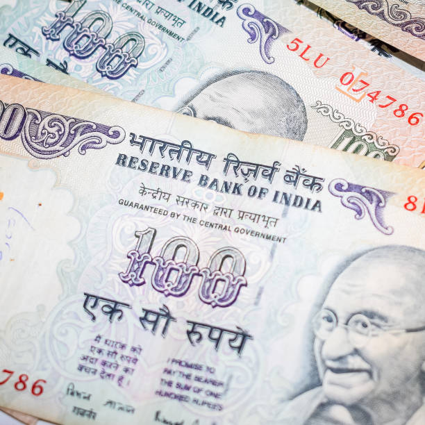 istock Old One Hundred Rupee notes combined on the table, India money on the rotating table. Old Indian Currency notes on a rotating table, Indian Currency on the table 1371359492