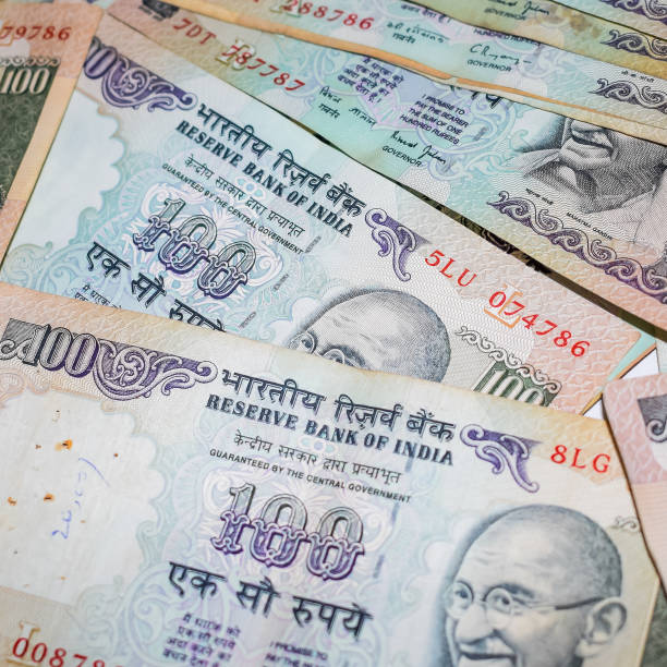 istock Old One Hundred Rupee notes combined on the table, India money on the rotating table. Old Indian Currency notes on a rotating table, Indian Currency on the table 1371359498