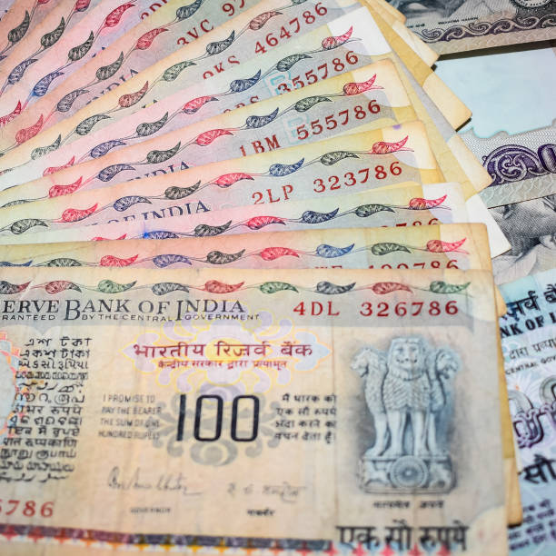 istock Old One Hundred Rupee notes combined on the table, India money on the rotating table. Old Indian Currency notes on a rotating table, Indian Currency on the table 1371359551