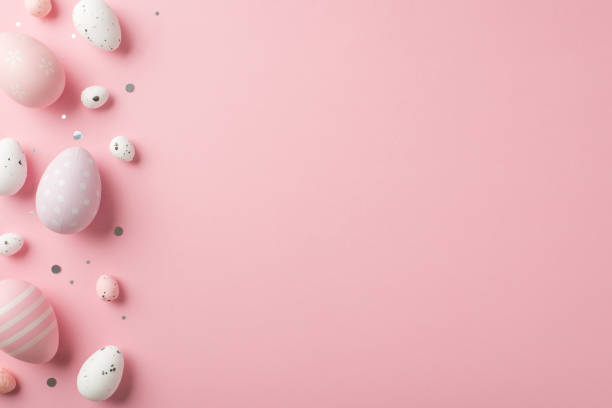 istock Top view vertical photo of easter decorations shiny confetti lilac pink and white easter eggs on isolated pastel pink background with copyspace 1371359790