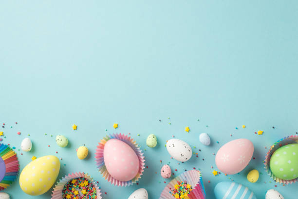 istock Top view photo of easter decorations multicolored easter eggs in paper baking molds and confectionery topping on isolated pastel blue background with copyspace 1371360104