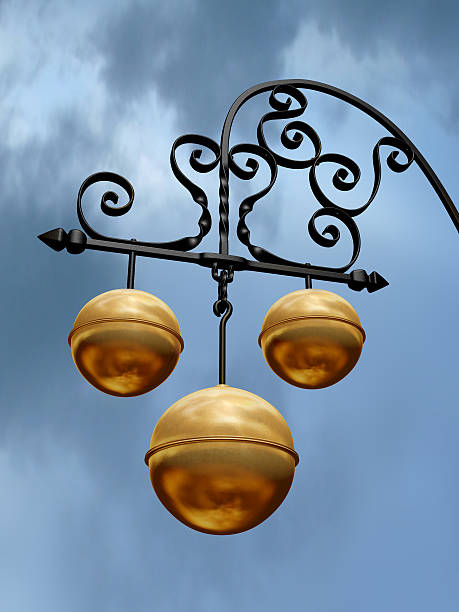 Pawnbroker symbol with three gold balls on black hanger stock photo