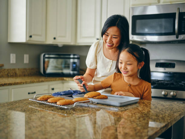 istock Mom and Children Baking Cookies 1371360329