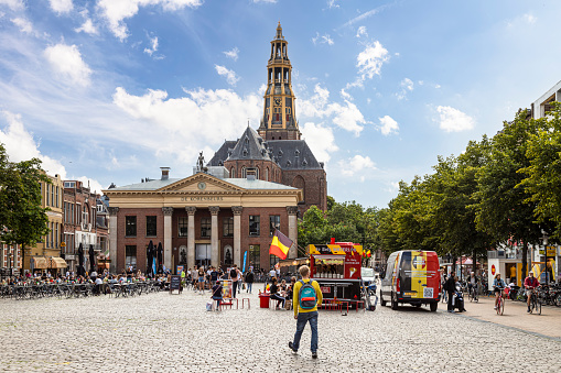 Groningen, The Netherlands, August 4, 2021; Grain exchange building and church tower on the fish market square in the student city of Groningen.