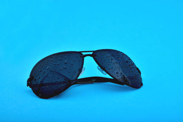 blue glasses on a blue background with water drops, close-up
