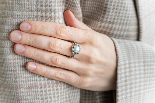 Close up of a woman's hand wearing a ring