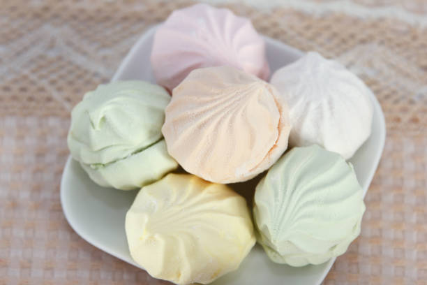 istock Delicious fresh multicolored marshmallow lies on a serviced table in saucers 1371370071