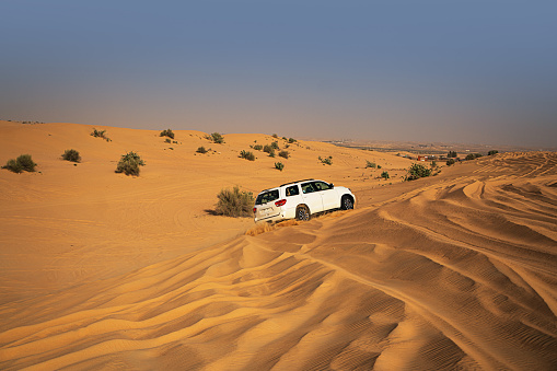 A four by four driving in Dubai desert - United Arab Emirates
