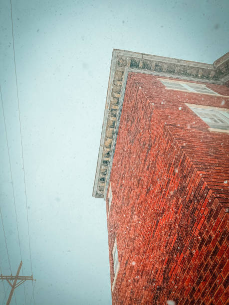 istock Snowfall on a Red Brick Apartment Building 1371372946