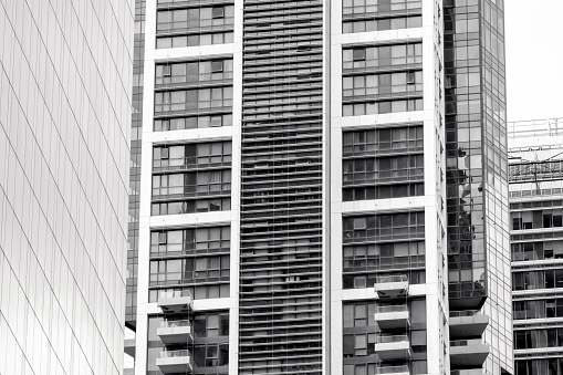 Black and white closeup modern office buildings, skyscrapers, abstract background with copy space, full frame horizontal composition