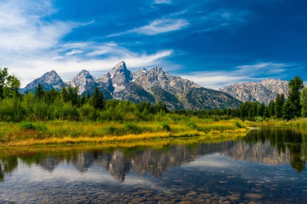 Grand Teton National Park, Wyoming Teton Mountains reflect in water of Snake River in Grand Teton National Park rocky mountains stock pictures, royalty-free photos & images