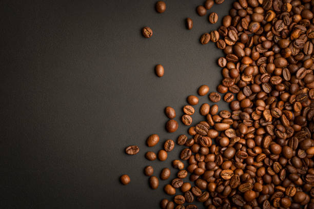 Coffee Beans on Black Table. Top View Background with Copy Space stock photo