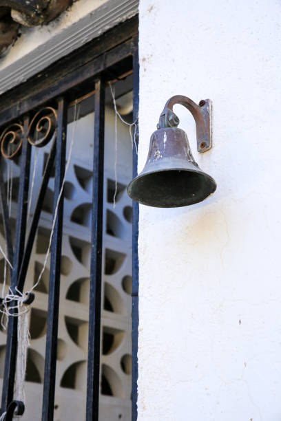 istock Metal door bell on white facade in Spain 1371381623