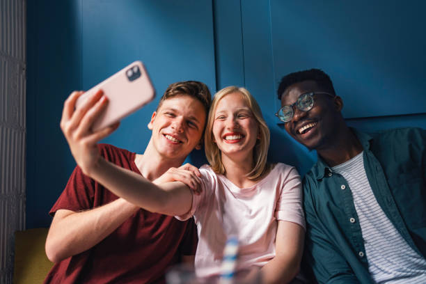 istock Three Cheerful Friends Taking Selfie in a Coffee Shop 1371381678