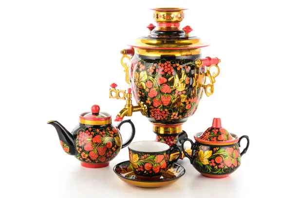 Gold Black Red Tea Set of Old Traditional Russian folk utensils. Dishes with handmade painting floral ornament in style of Khokhloma isolated on white background.