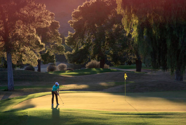 istock Caucasian Male Golfer Putting at Twilight 1371391249