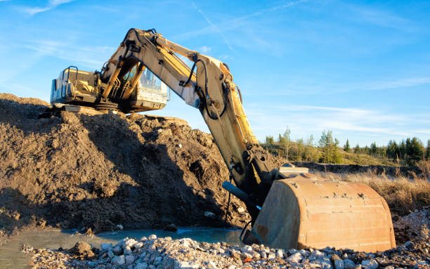 istock Yellow excavator on a road construction site 1371391901